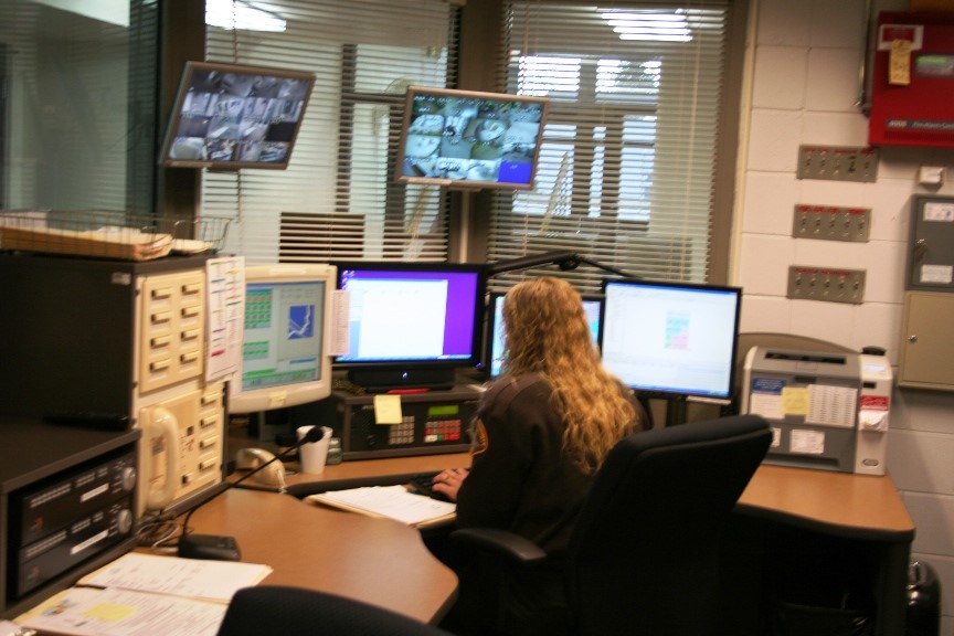 Woman taking a 911 call - back view